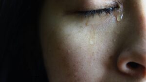 close up of tears falling on womans face